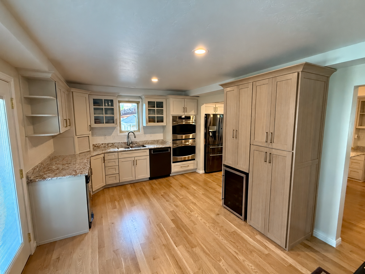 AFTER | Bountiful, Utah Kitchen Cabinet Refinishing & Refacing: CAZI Refined Finishes transformed the existing cherry cabinetry with Sherwin-Williams SW 9530 Taupe of the Morning and completely refaced the tall cabinet in Rift White Oak with new Shak