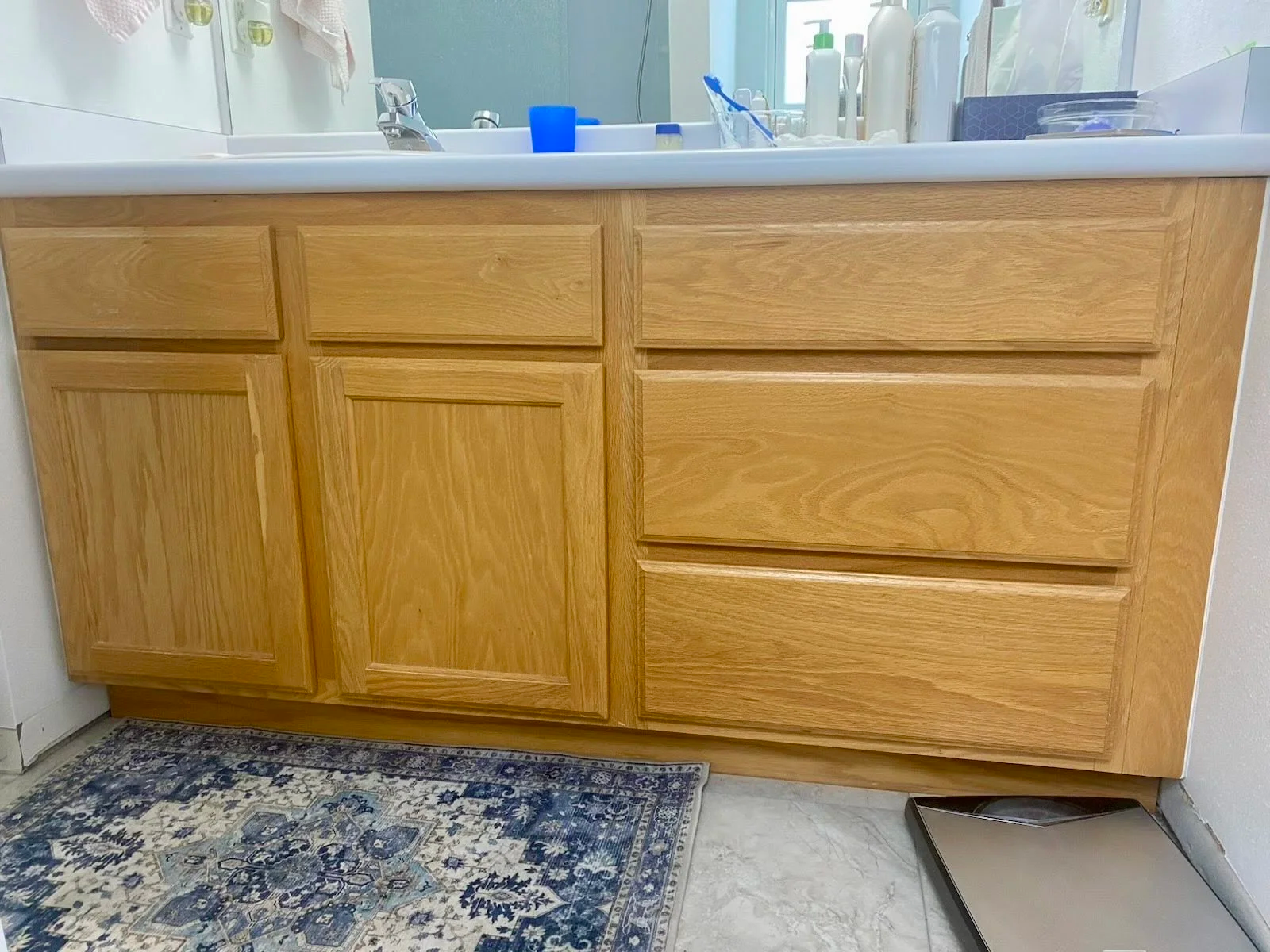 Wide bathroom vanity in Provo Utah before cabinet refinishing, new Shaker doors and soft close hinges.