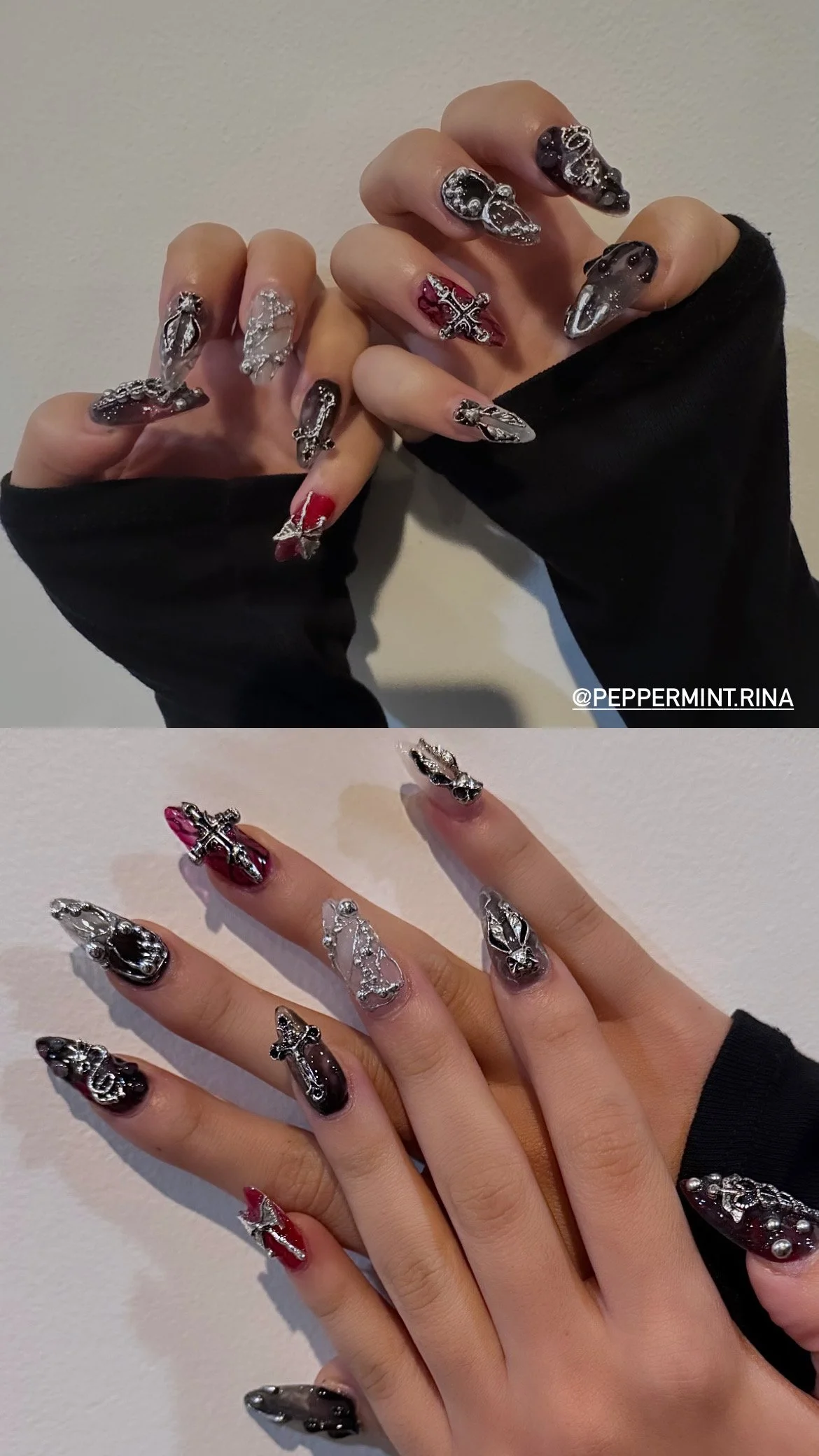 Close-up of hands with elaborate gothic-style nail art featuring black, red, silver, and clear nails with metallic and rhinestone embellishments.