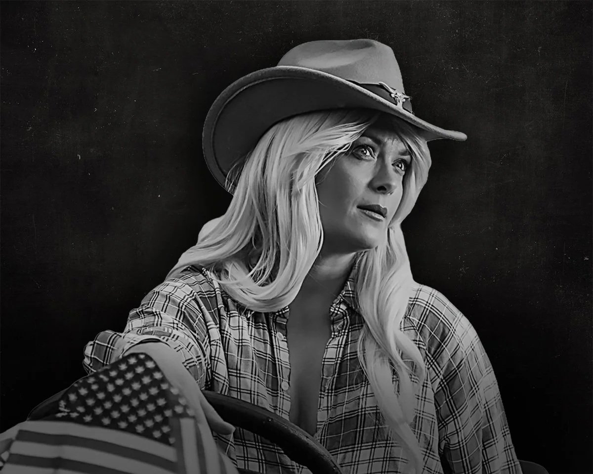 A black-and-white side profile of a woman wearing a baseball cap and a long-sleeved, polka-dotted top, adjusting the cap with her hand against a dark background.