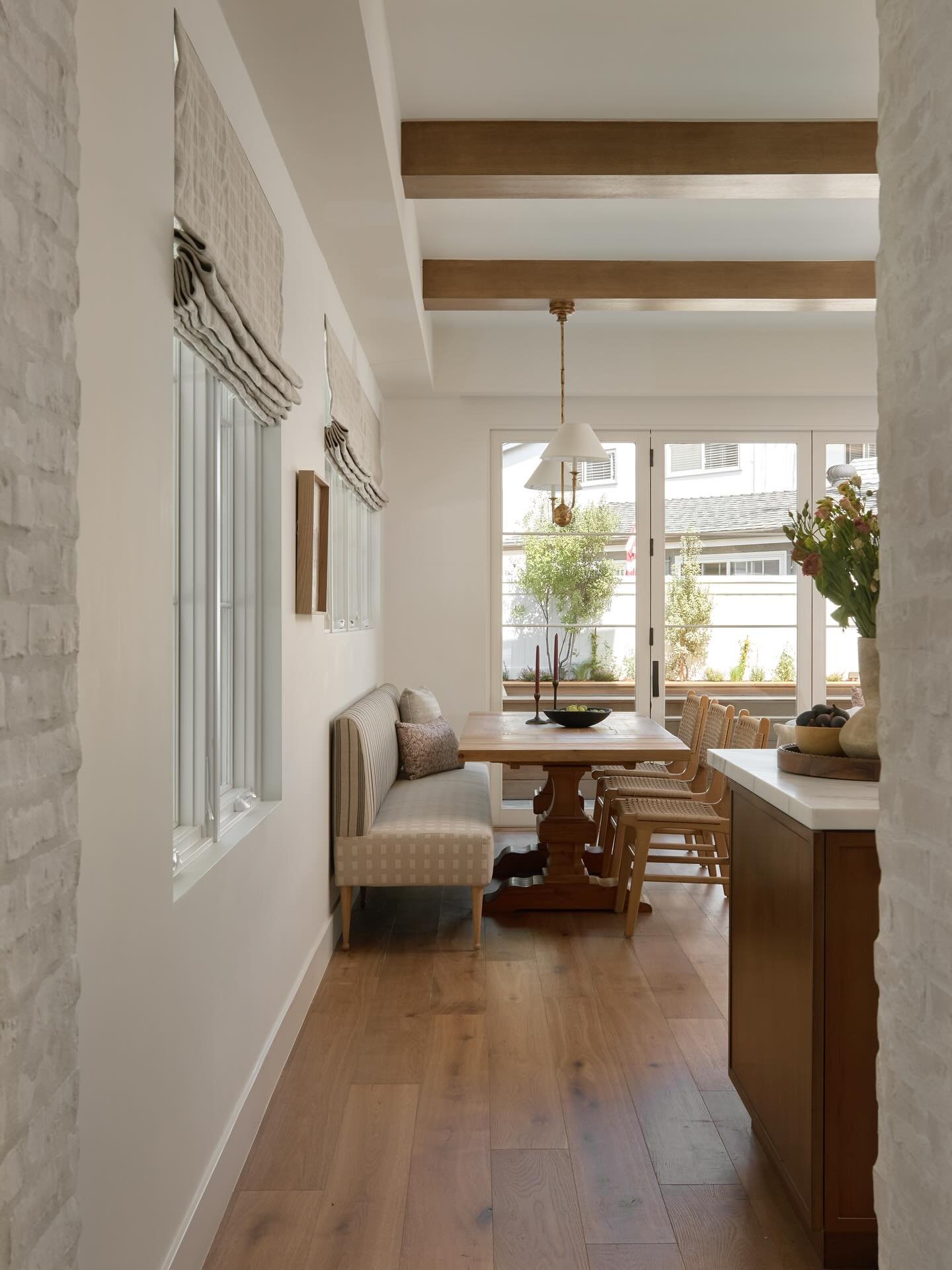 A peek down the hallway at our Valley dining area. We created a long custom bench with some fun pattern mixing. The clients were trusting enough to go for it and it turned out great! 

Interior design @juliedonovandesign 
Photo by @public311design