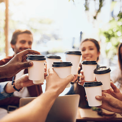 Employees enjoying coffee at a corporate event with Wildshine Coffee catering.
