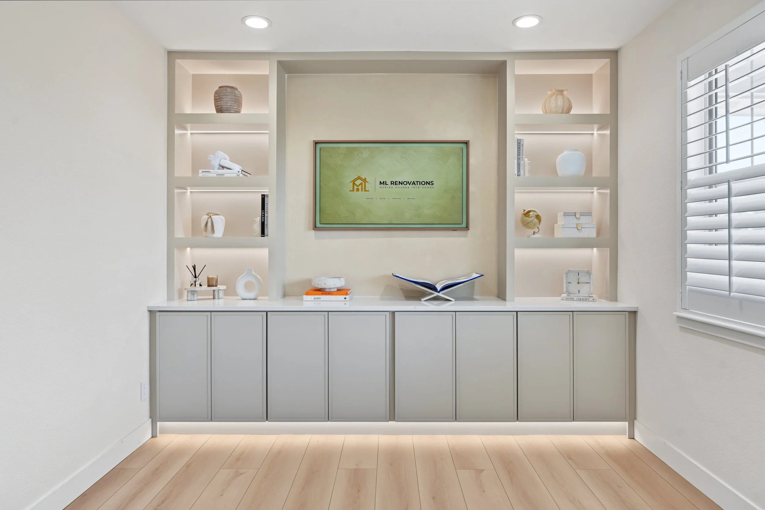 Custom built-in with shelves, cabinets and ambient lighting.