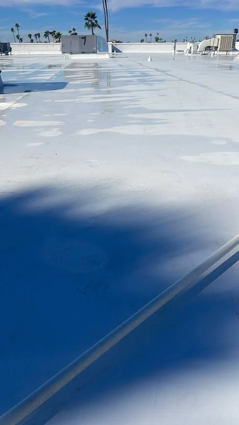 Completed white commercial low-slope roofing system.