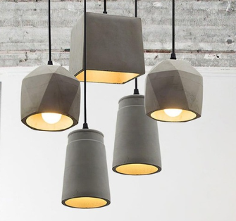 Modern pendant lights hanging from the ceiling, with three cylindrical shades and two box-shaped shades.