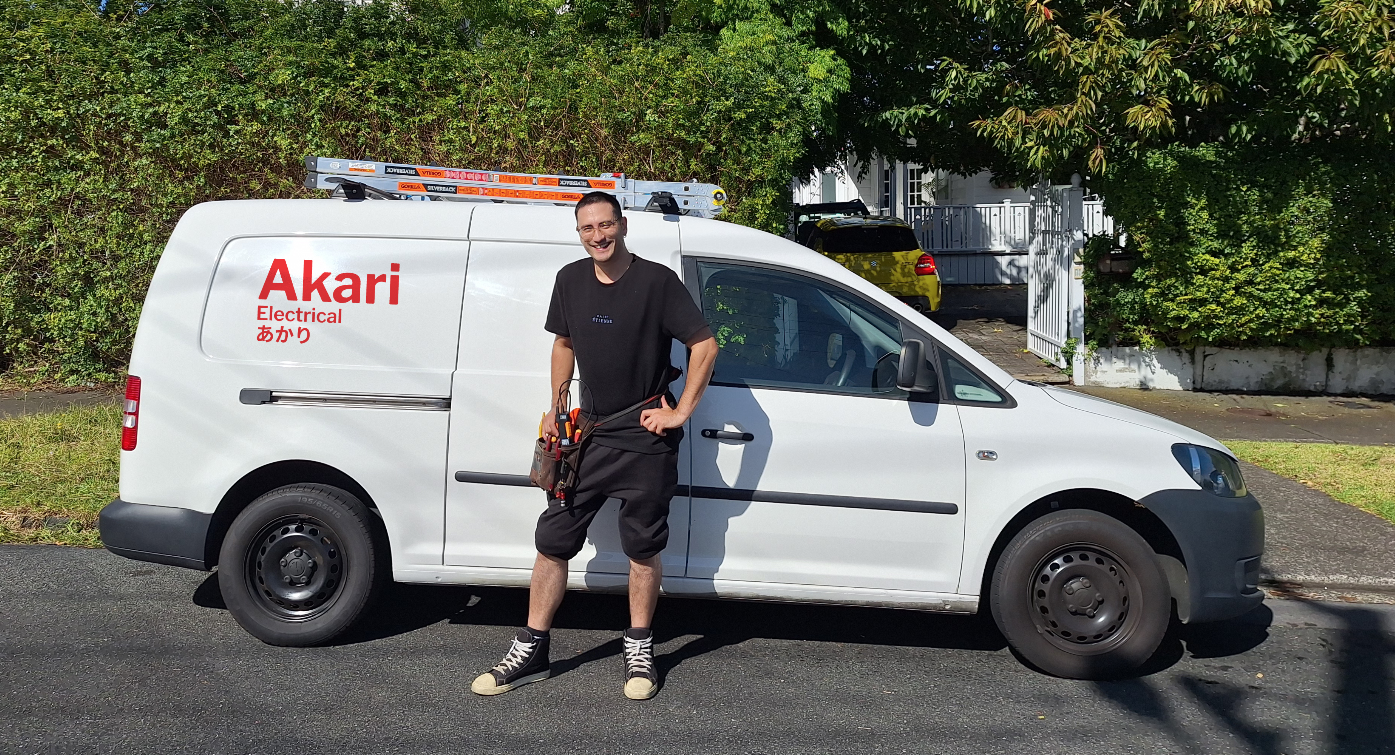 Nick standing in front of work van