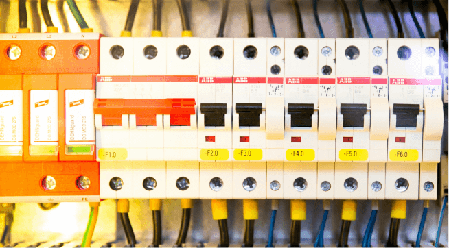 Electrical circuit breaker panel with multiple switches labeled with voltage ratings.