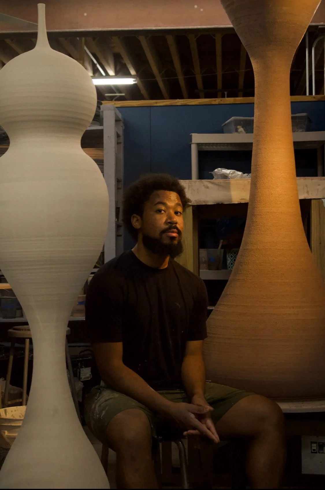 Khalil Jannah seated in the studio with monumental wheel-thrown ceramic forms (Chasing Giants)