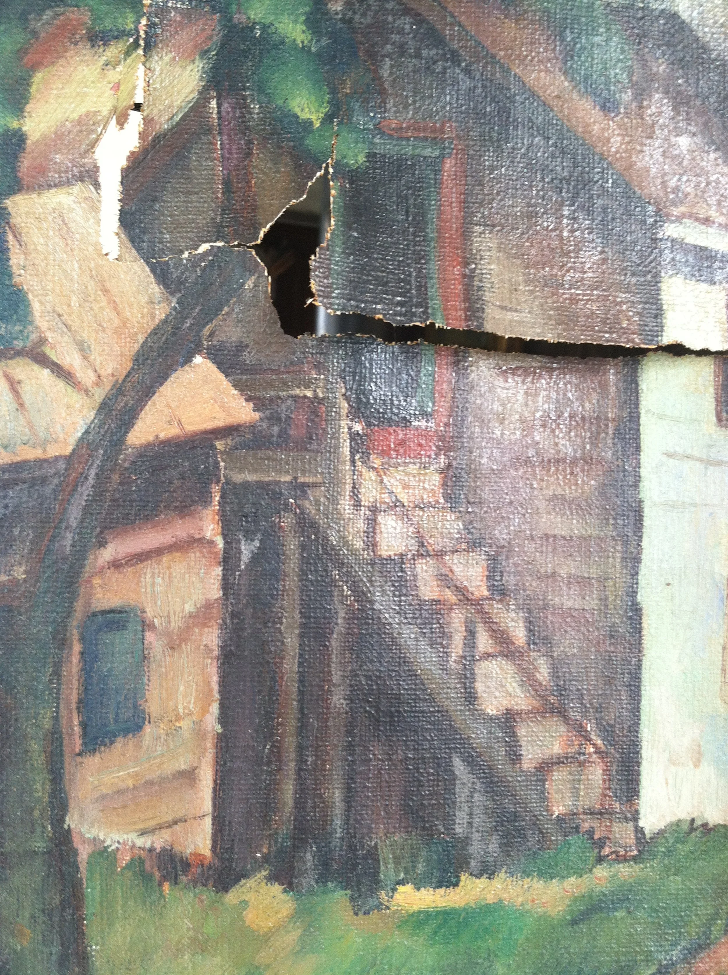 Close-up of a damaged oil painting depicting a house with a staircase, with a tear and hole in the canvas.