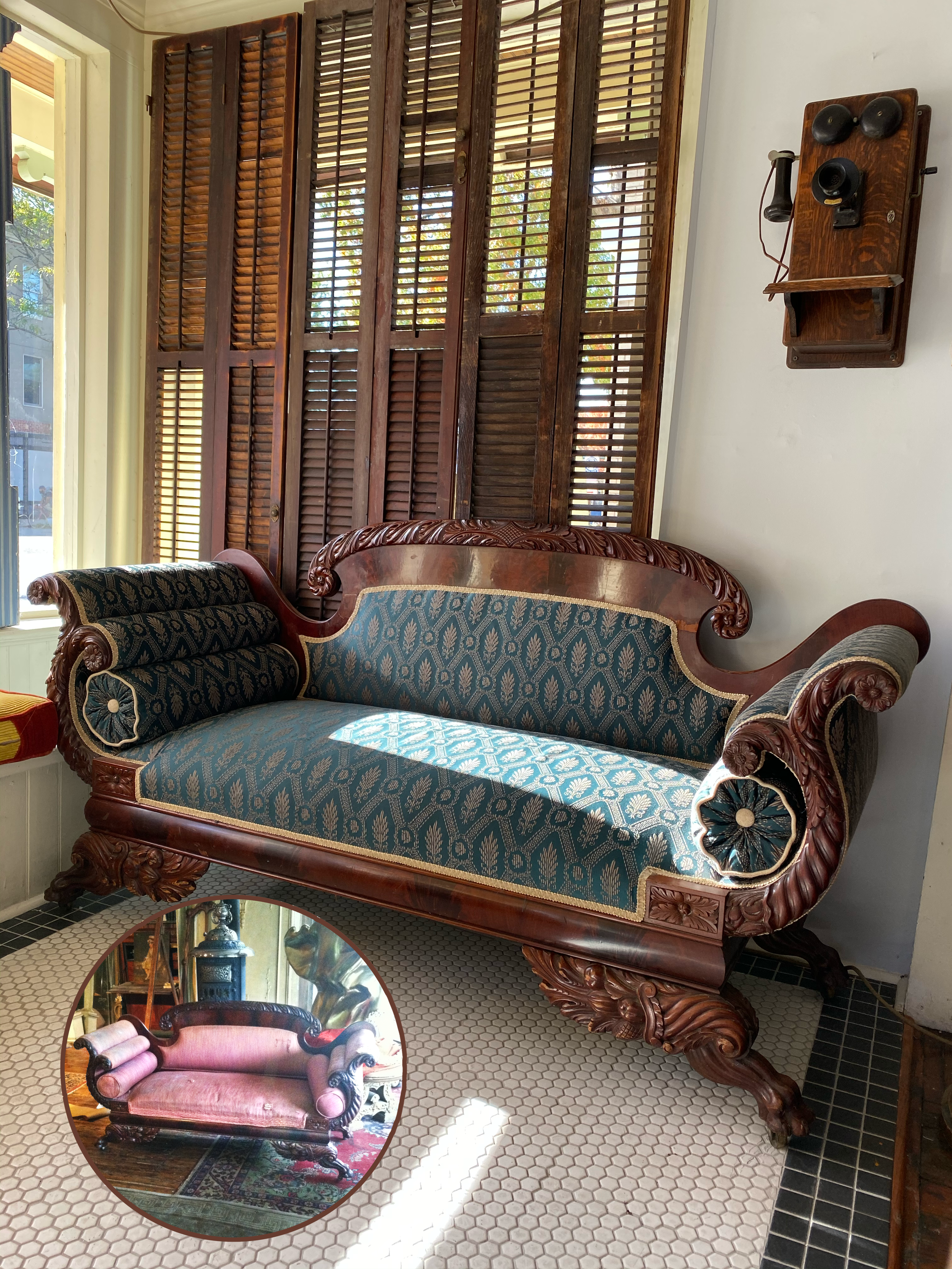 A vintage wooden sofa with blue patterned upholstery, ornate carved wooden arms and legs, placed in a room with wooden shutters, a white wall, and a vintage wall-mounted telephone. An inset image shows the same sofa before restoration.