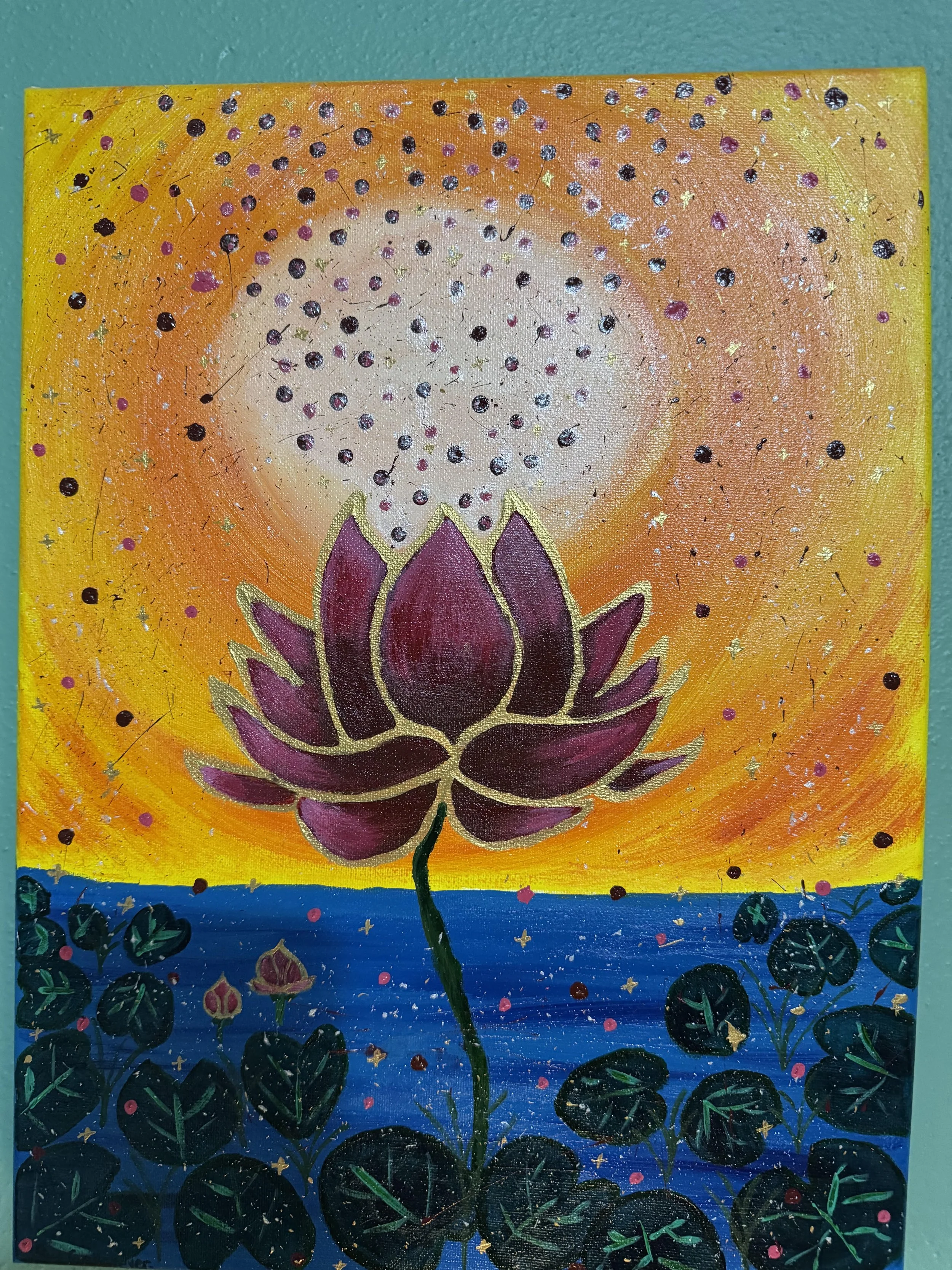 Painting of a purple lotus flower in a blue pond with a vibrant orange and yellow sky and the sun with sprinkles of energy from the flower in the air.
