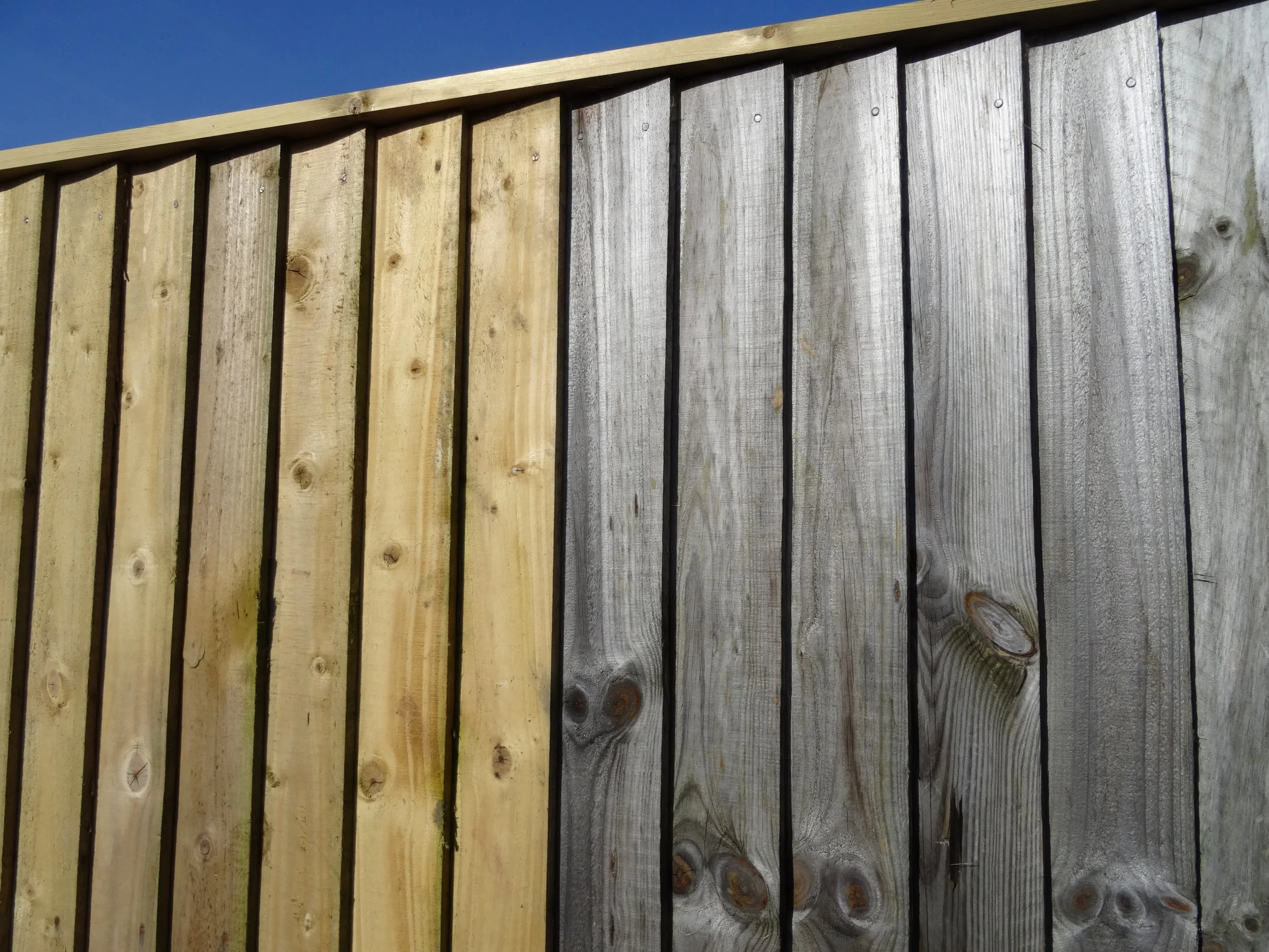 Fence before and after pressure washing