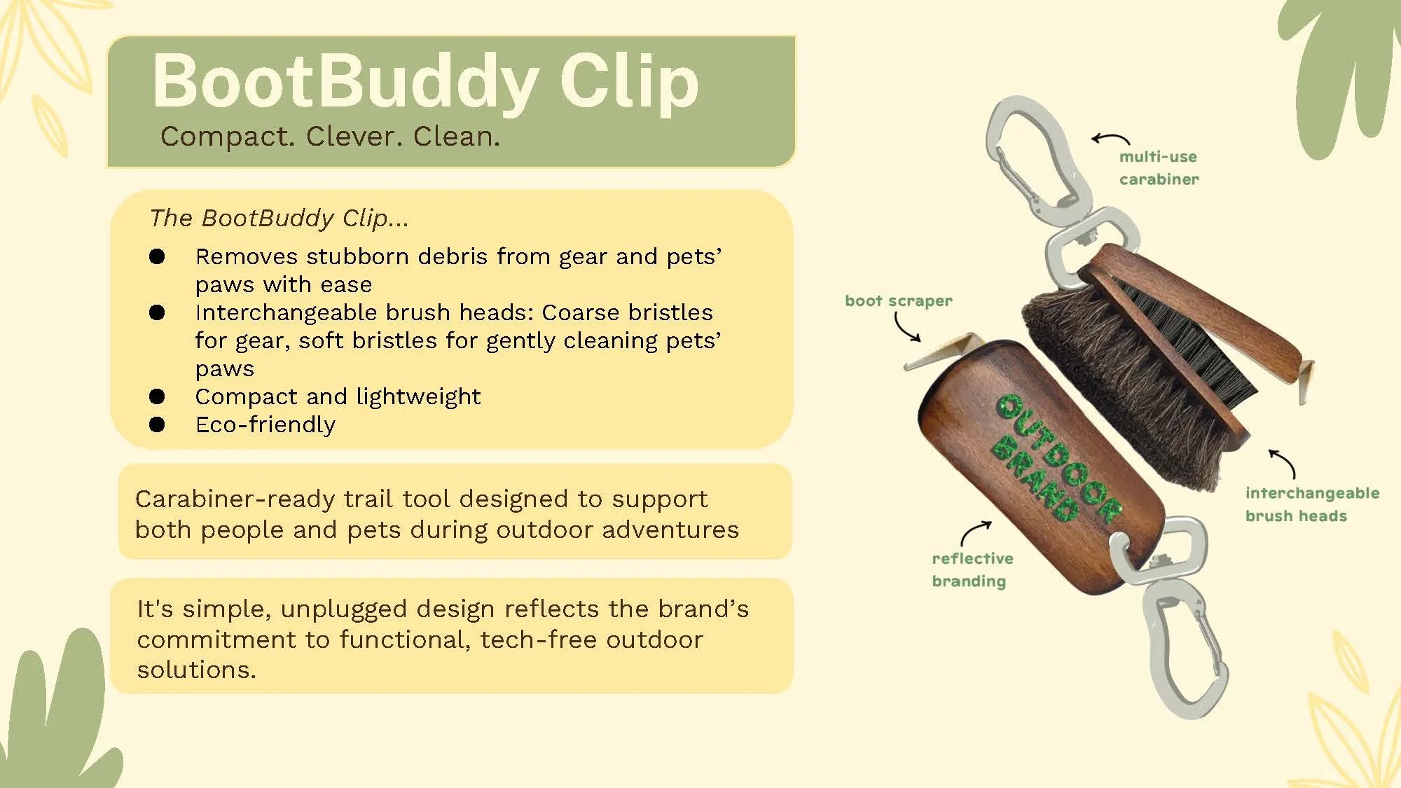 A Trail tool called BootBuddy Clip with a wooden handle and black brush head, with multi-use carabiner, reflective branding, and interchangeble brush heads for gear and pet paws, designed for outdoor cleaning.