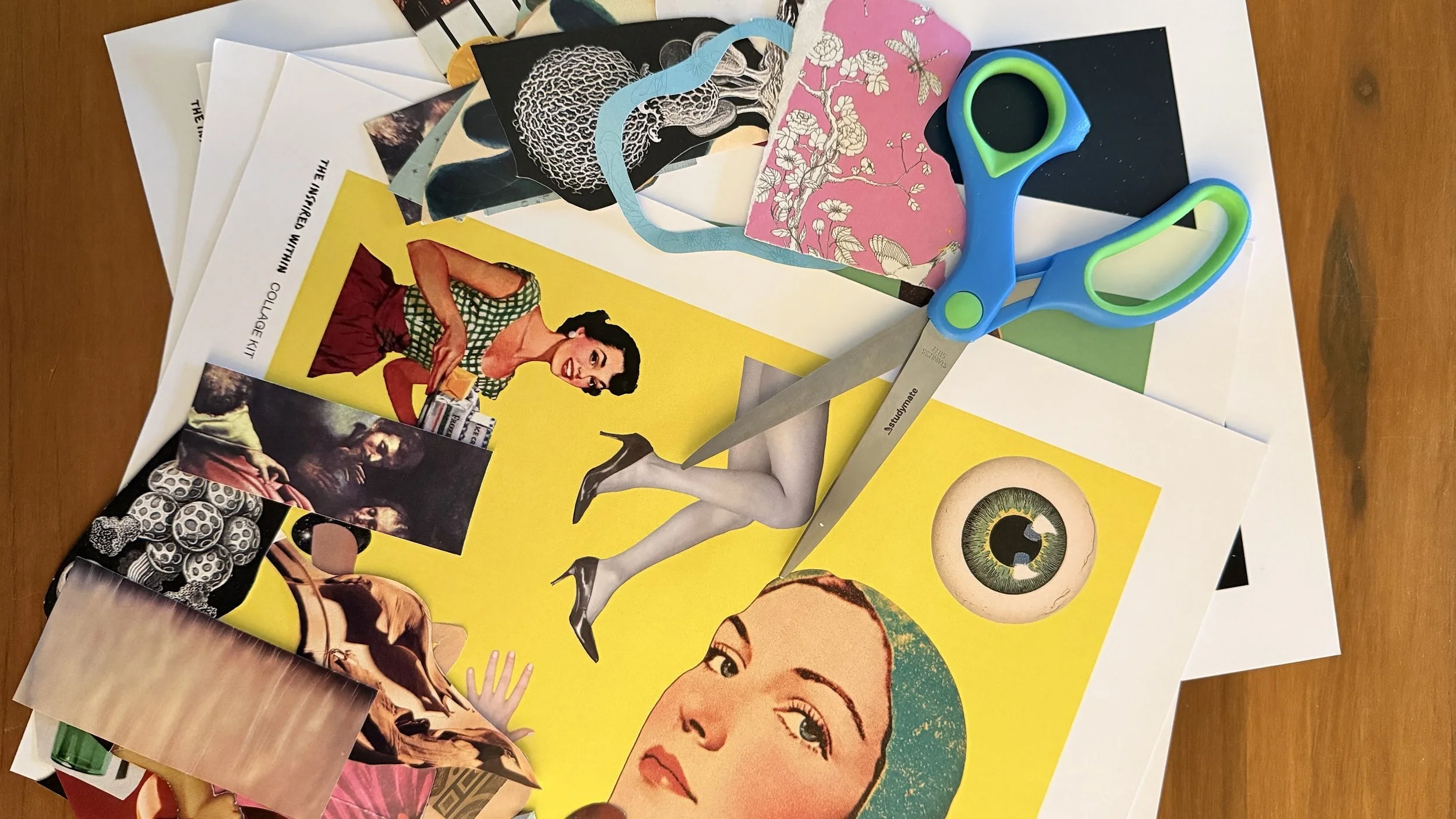 A scattered collection of colorful magazines, photos, and paper cutouts, along with a pair of blue and green scissors on a wooden surface.