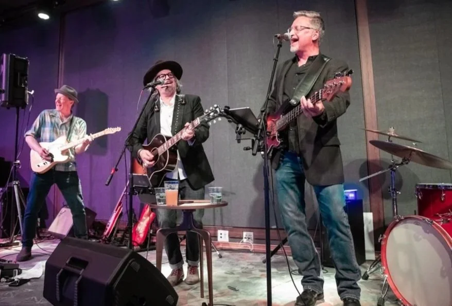 Dave Nielsen on stage singing and playing bass