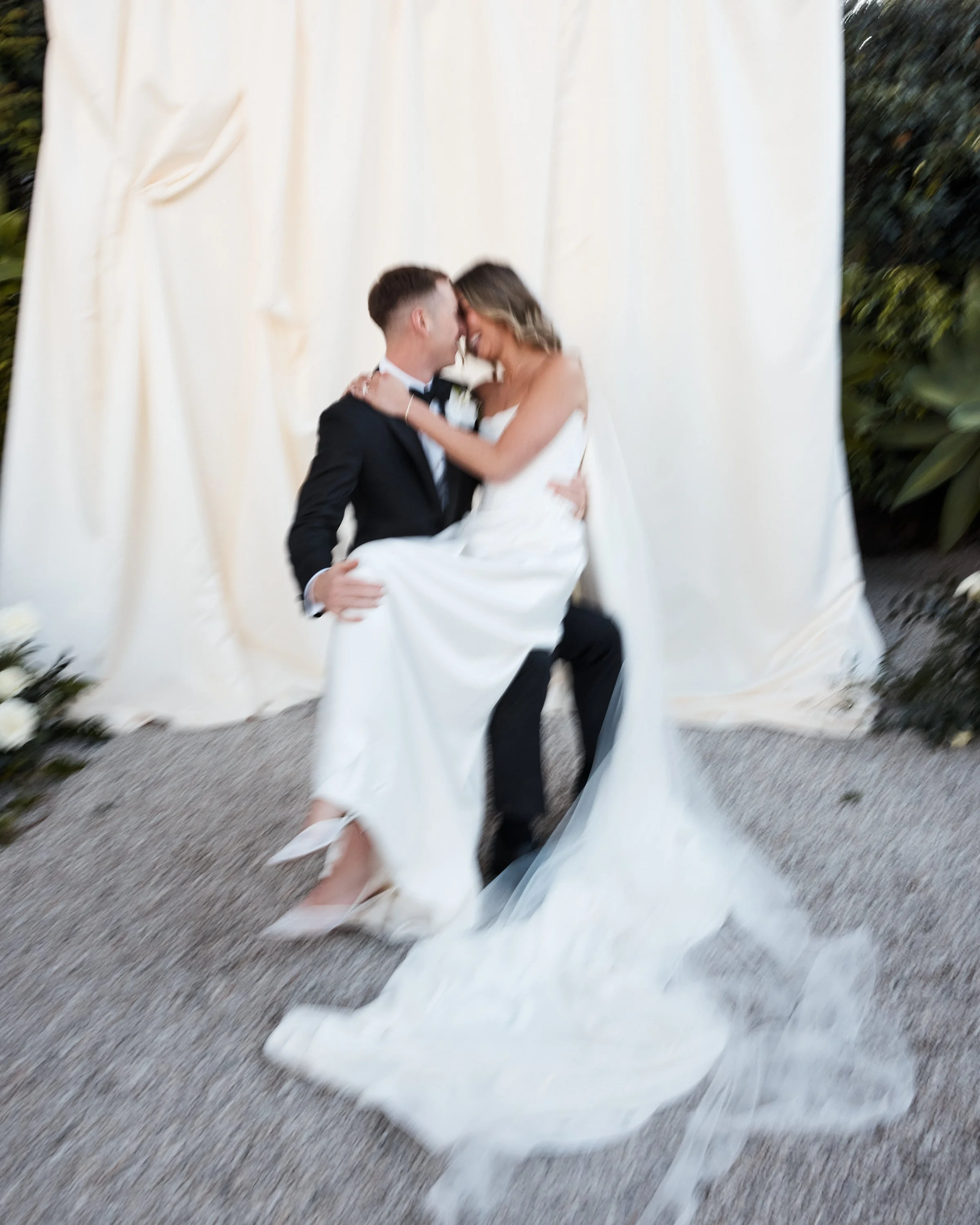 Photo of Bride and Groom Kissing. Editorial style image photographed by a fashion photographer. 