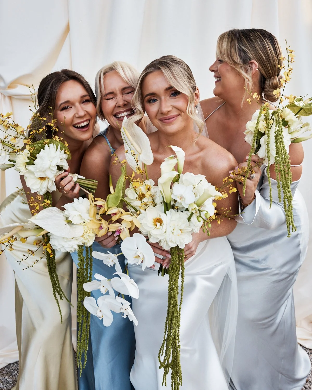 Bride and bridesmaid looking elegant at a wedding photographed by a fashion photographer with professional lighting. Think Vanity fair or Vogie editorial style image.