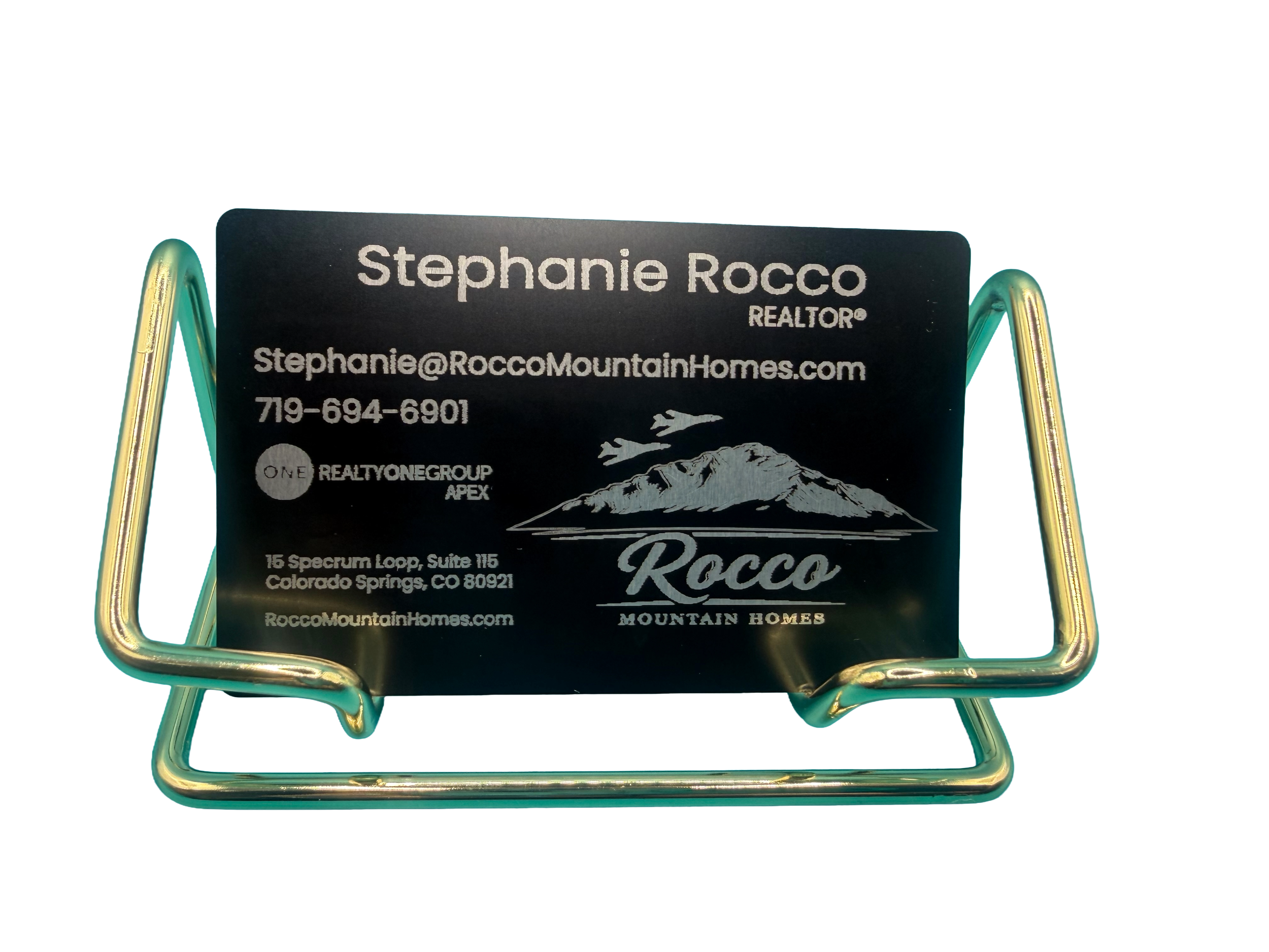 Business card for Stephanie Rocco, a realtor, featuring mountain and airplane graphics, with contact information and logo for Rocco Mountain Homes.