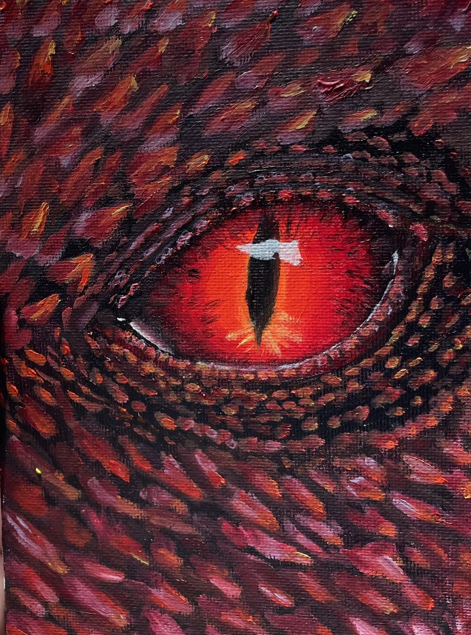 A close-up painting of a dragon's eye with a slit pupil, featuring vibrant red, orange, and black colors, surrounded by textured scales.