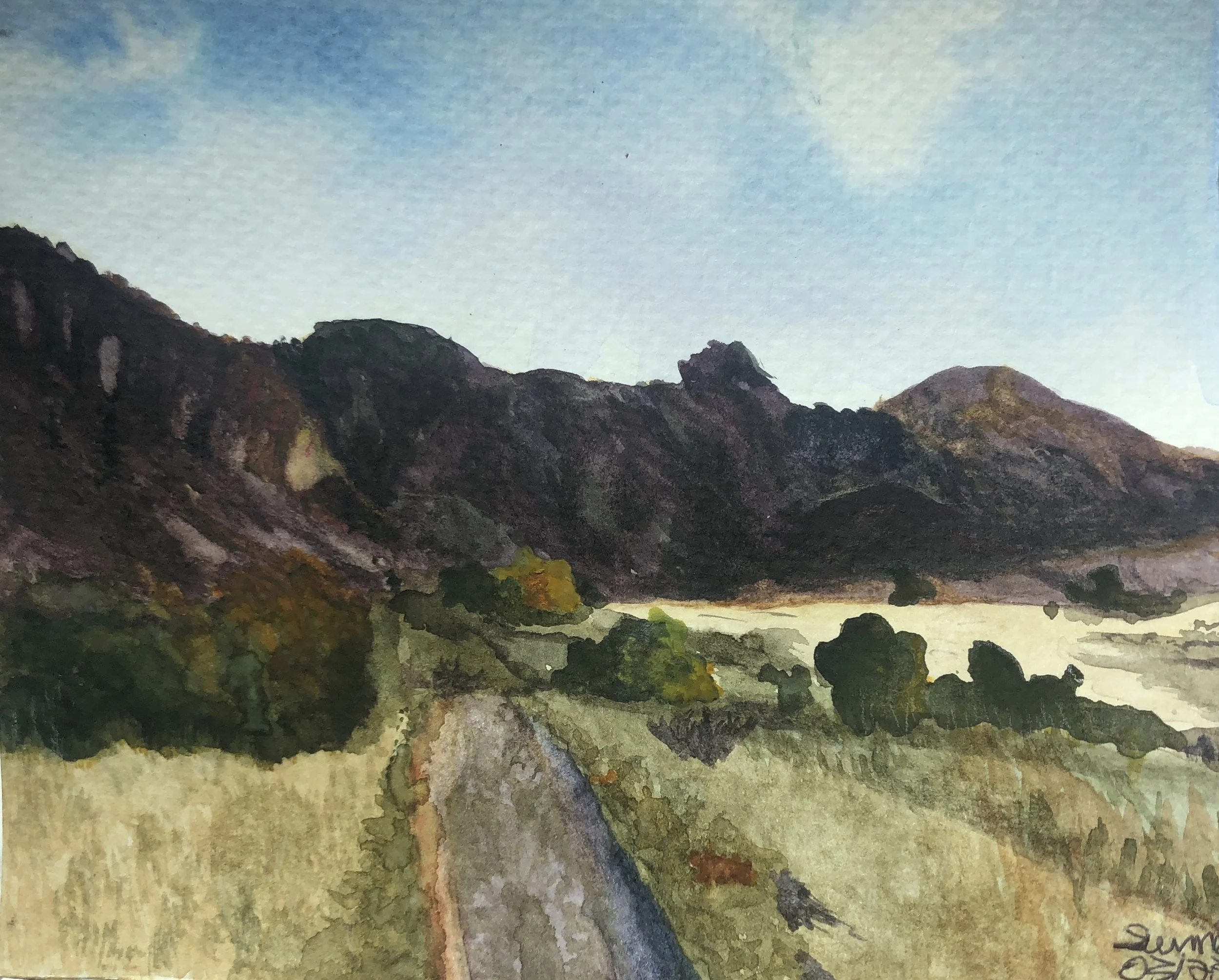 Watercolor painting of a mountain landscape with a dirt road leading towards the mountains, green trees and grass, a blue sky with a few clouds.