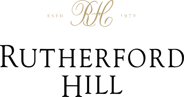 Black background with gold and white text that reads "RHC ESTD 1972 RUTHERFORD HILL."
