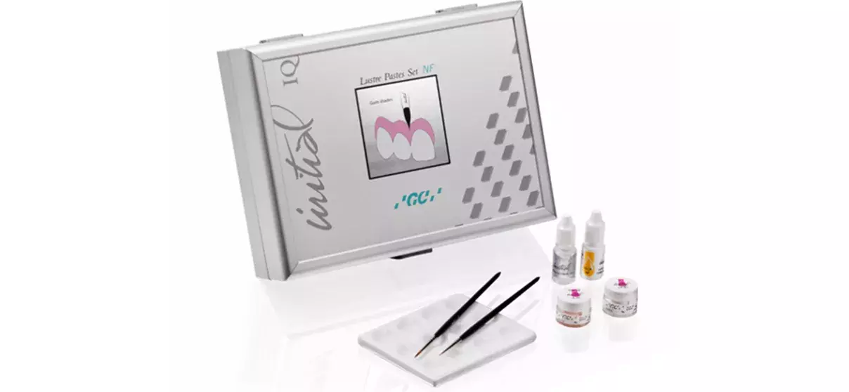 Orthodontic dental supplies including a sterilizer, dental paste set, tool tweezers, and small containers on a white surface.