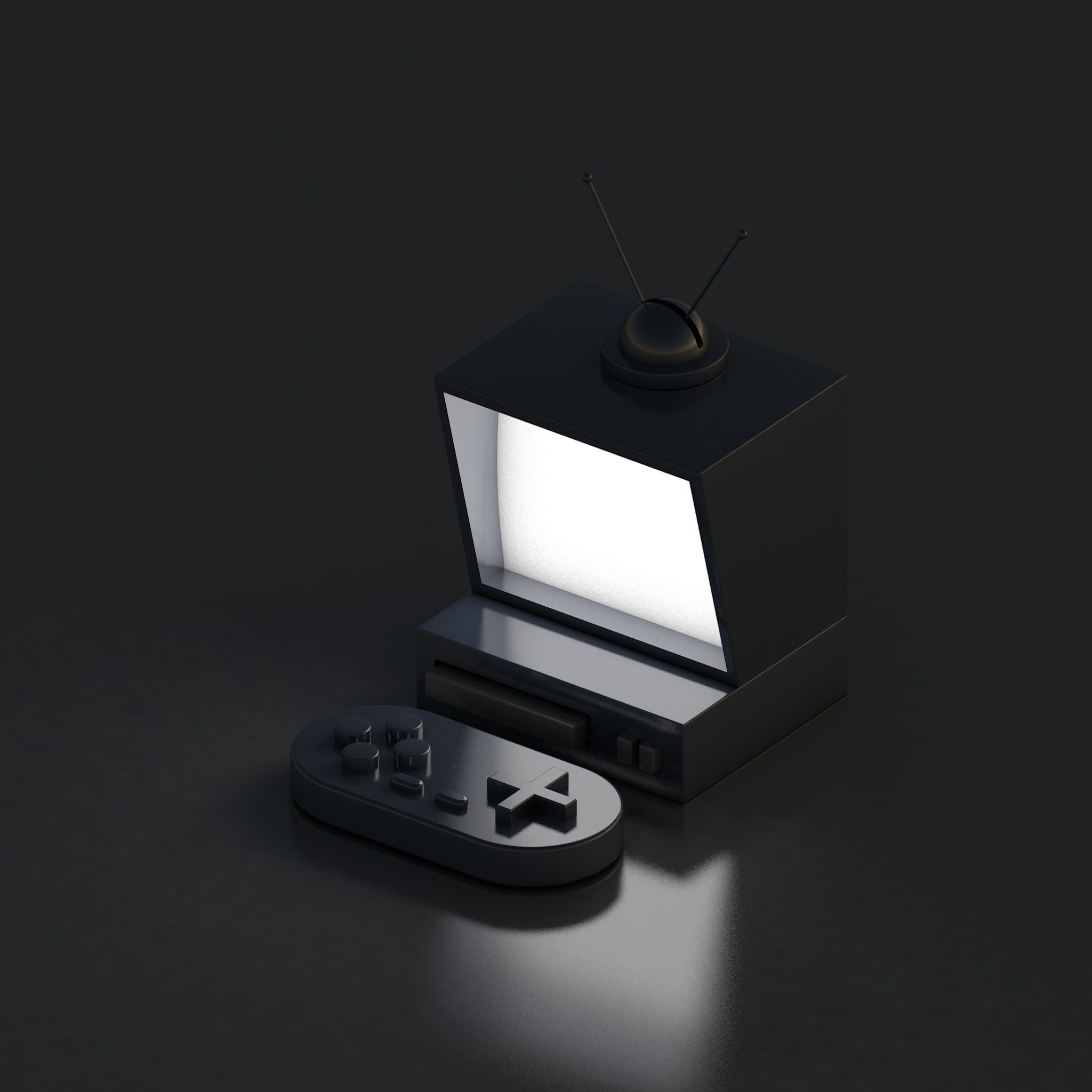 A vintage black television with a television antenna and a game controller placed in front of it on a dark surface.