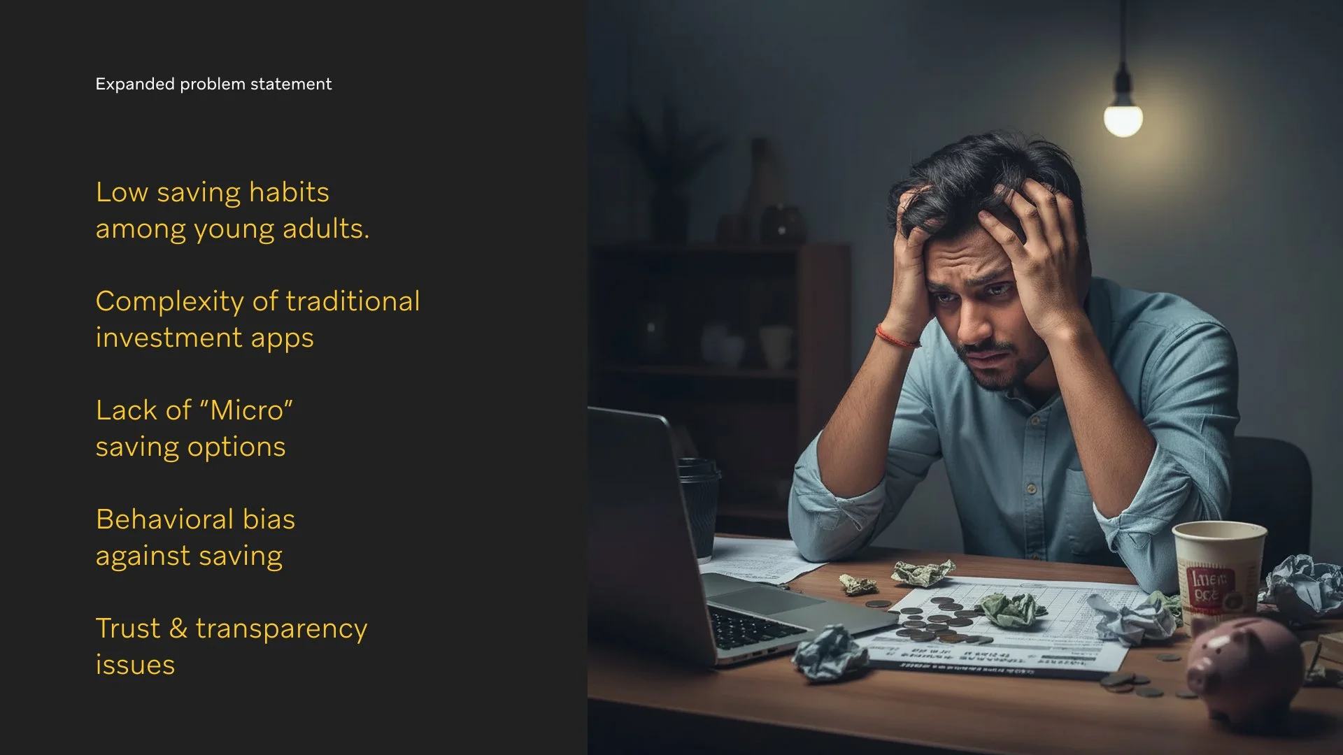 A worried man sitting at a cluttered desk with crumpled papers, coins, a piggy bank, and a laptop, illuminated by a single hanging lightbulb, during nighttime.