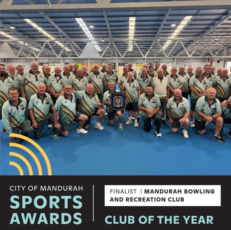 Group of men in matching sports shirts at Mandurah Sports Awards ceremony, posing for photo, some kneeling, inside a sports hall.