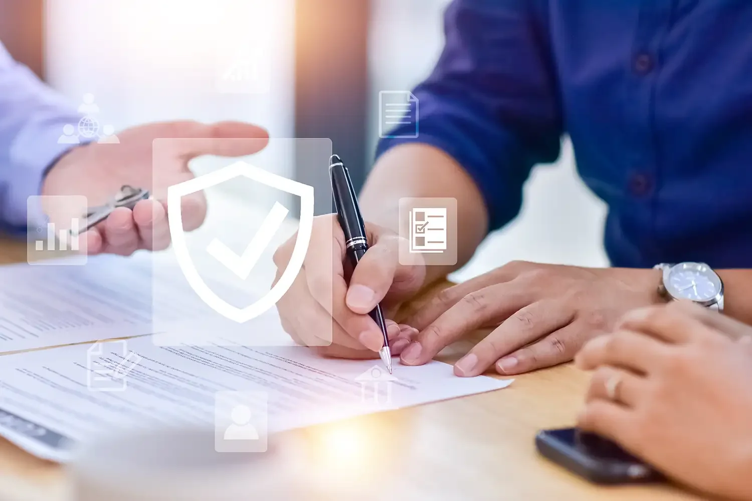 Two people sitting at a table, exchanging documents and signing papers, with digital icons overlayed representing security, checkmarks, and data.