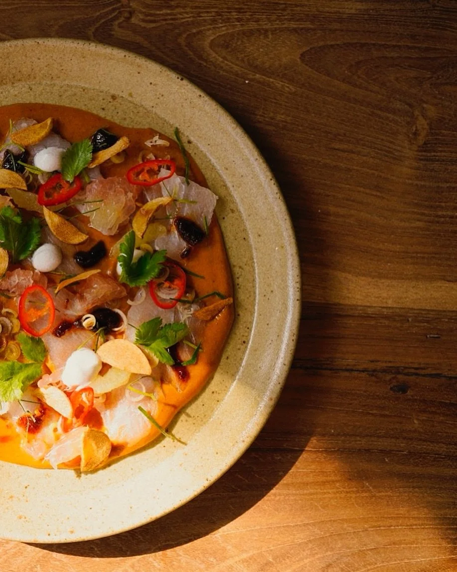 Our coco crudo is an homage to the flavors of tom yum - layered with hamachi, coconut cream, fresh herbs and citrus fruits like pomelo and lime, it&rsquo;s a feast for the senses and heart.