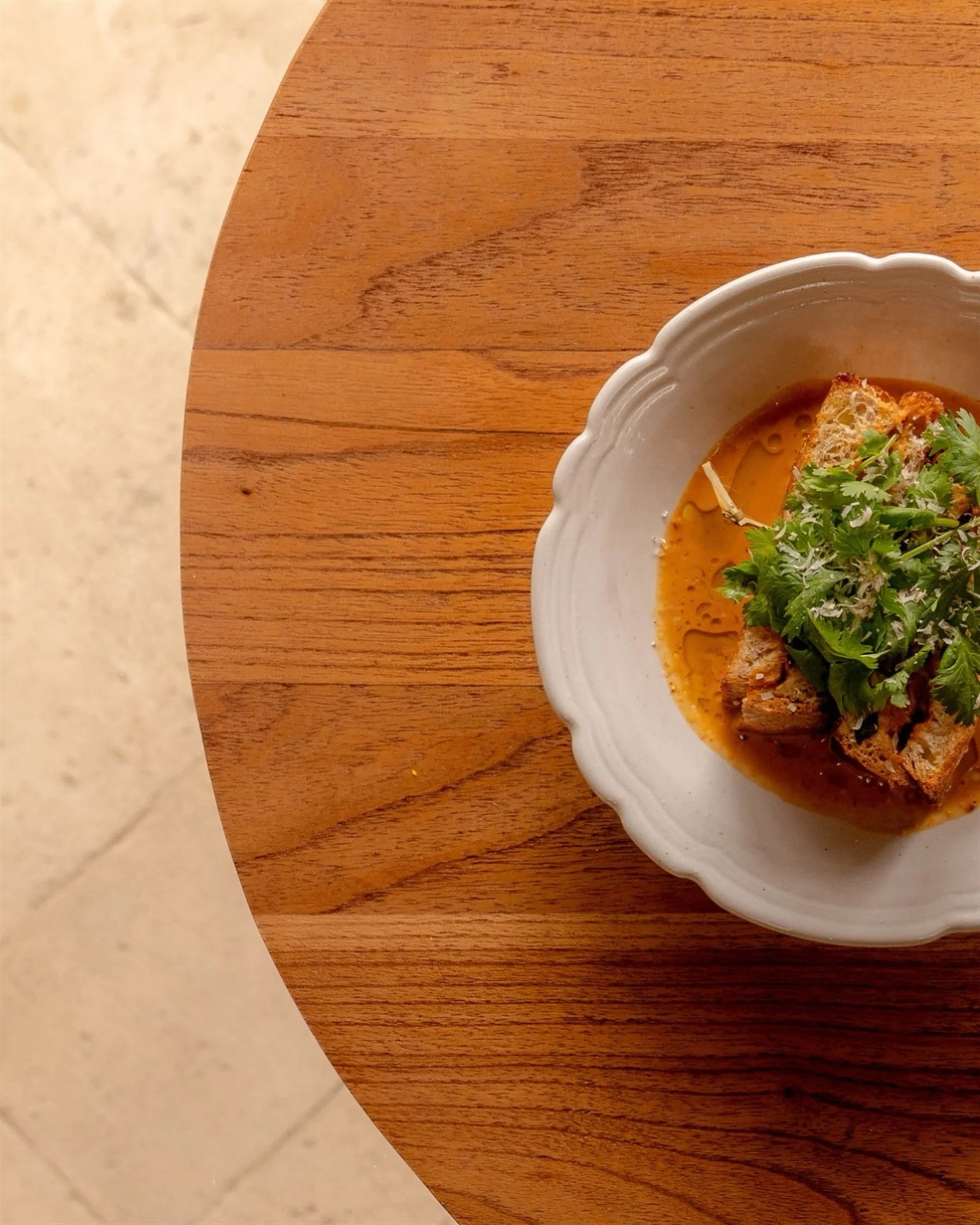 Remixing the classics with a steamed Thai curry seafood (Hor Mok) patty sandwiched in toasted sourdough, served over a velvet red curry sauce. A must do for lunch at Juna.
