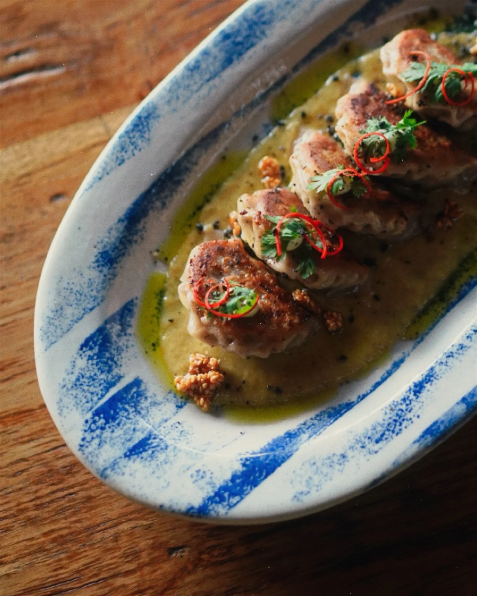 Handmade beef gyozas on a bed of fragrant green curry reduction, finished with a touch of Juna magic.

Join us for a comforting, Asian inspired menu on the daily, from 11am - 10pm. 

seeds | spices | senses