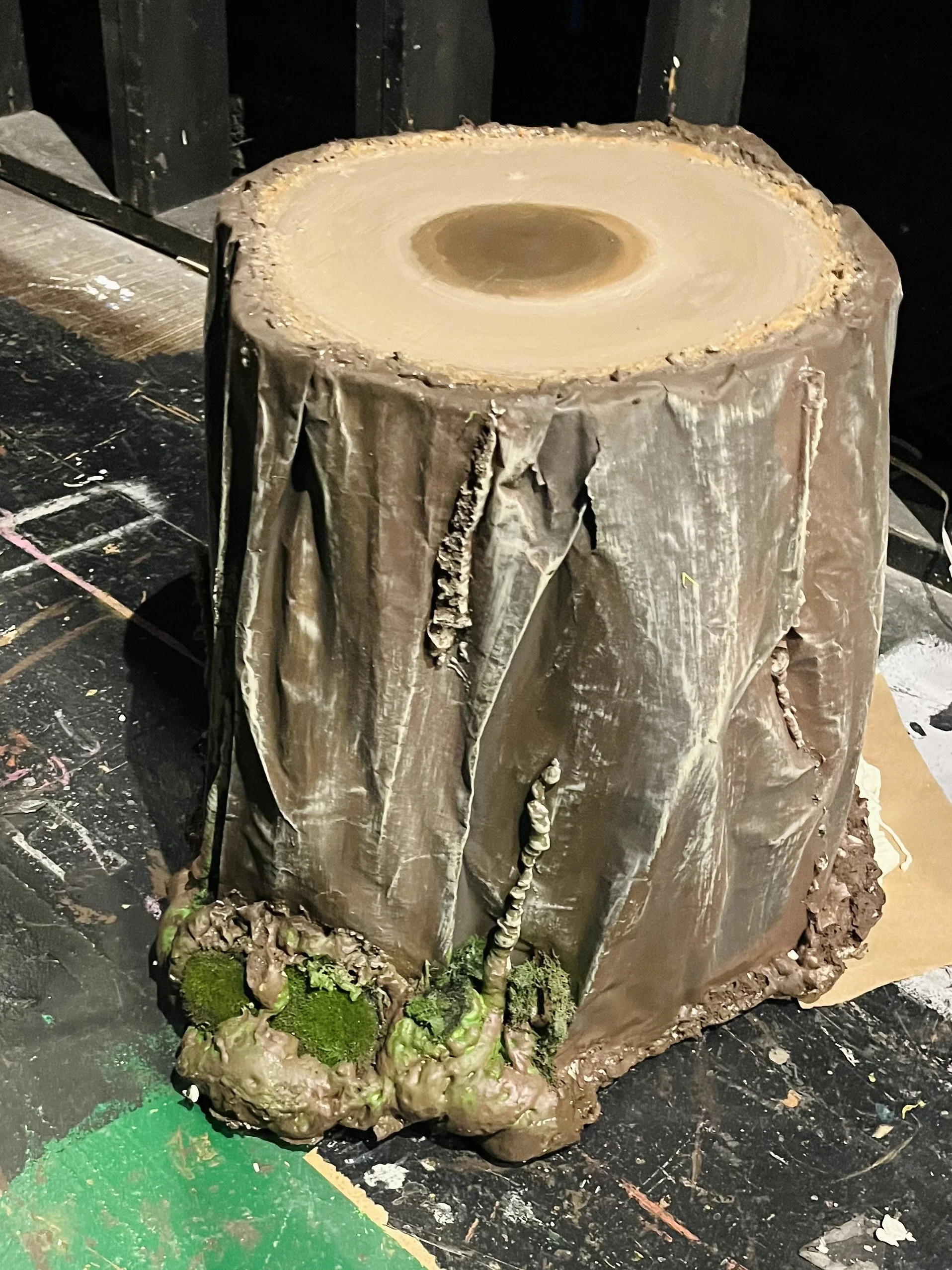 Tree stump made from plywood, paper, and insulation foam.