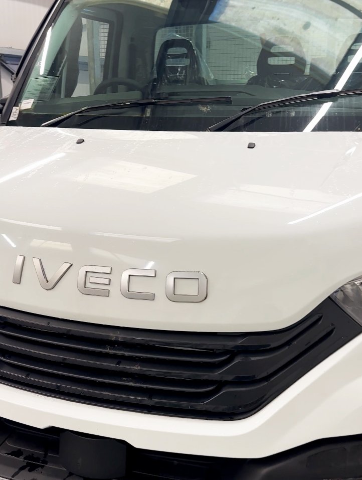 Front of a white Iveco truck with the brand name on the grille.