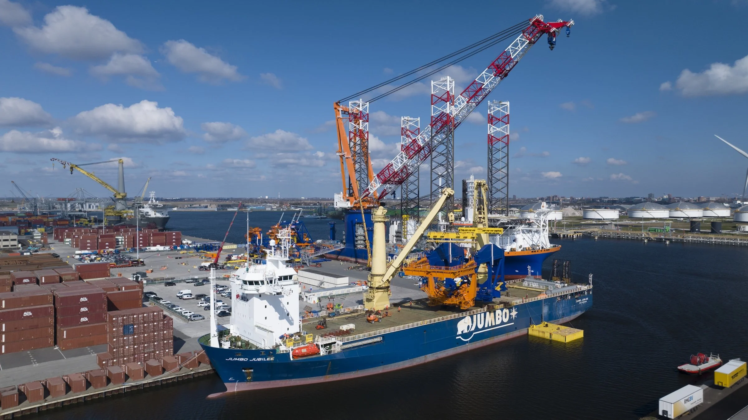 Jumbo Jubilee offloading operations TMA Terminal Amsterdam. Crane operations cargo positioning vessel coordination documented through drone aerial perspectives Port of Amsterdam Netherlands.