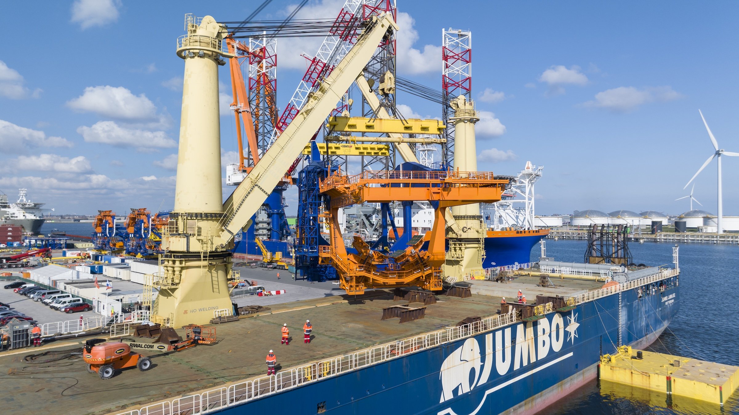Jumbo Jubilee crane operations cargo offloading Amsterdam IJmuiden. Maritime documentation capturing multi-ton lifts terminal coordination vessel operations Port of Amsterdam Netherlands.