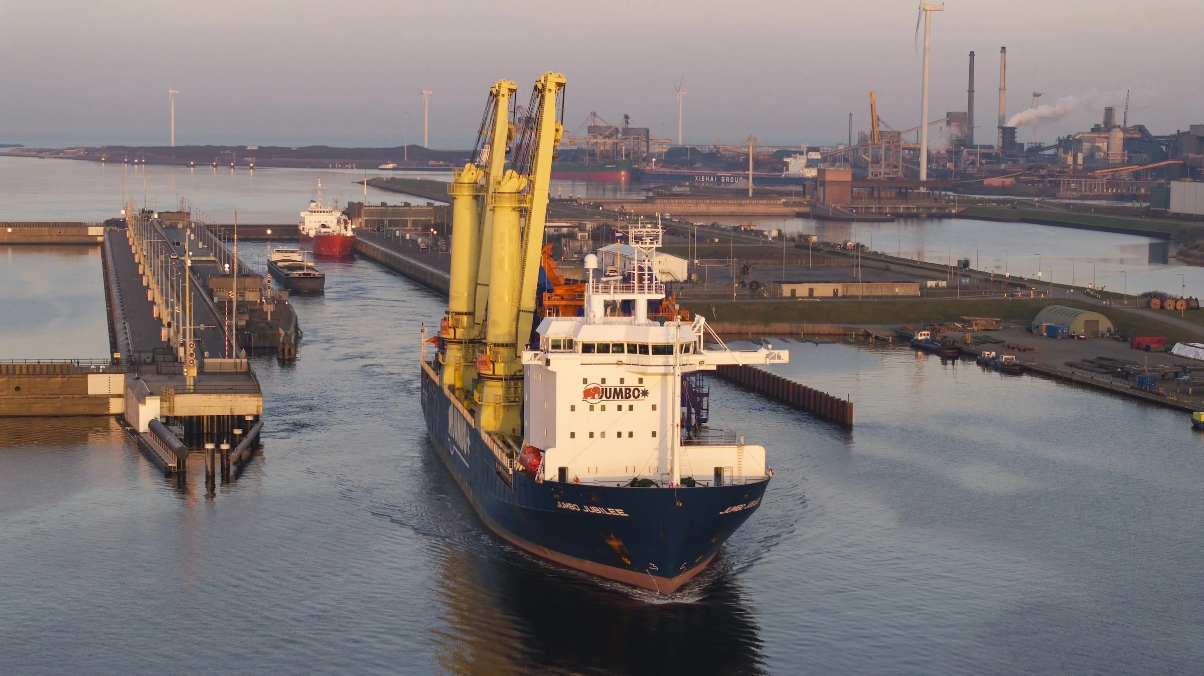 Jumbo Jubilee heavy-lift vessel arrival Port of Amsterdam IJmuiden Netherlands. Specialized cargo vessel documented during three-day offloading operation TMA Terminal controlled airspace.