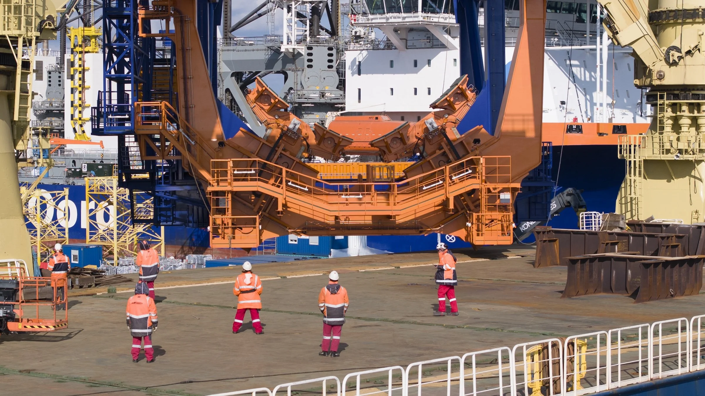 Jumbo Jubilee cargo positioning operations Port of Amsterdam Netherlands. Heavy-lift vessel documentation capturing crane coordination multi-ton lifts terminal operations IJmuiden.