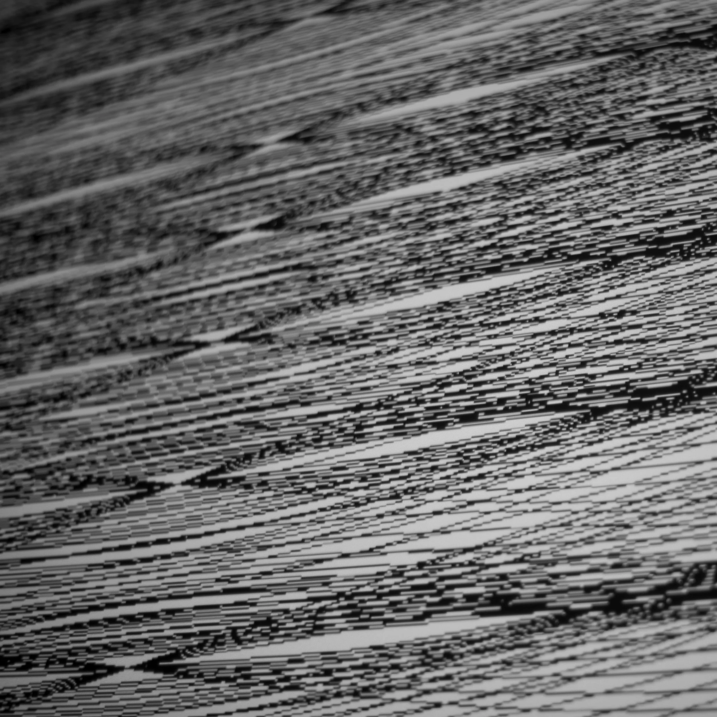 Close-up of a stack of printed papers or photographs with black and white patterns.