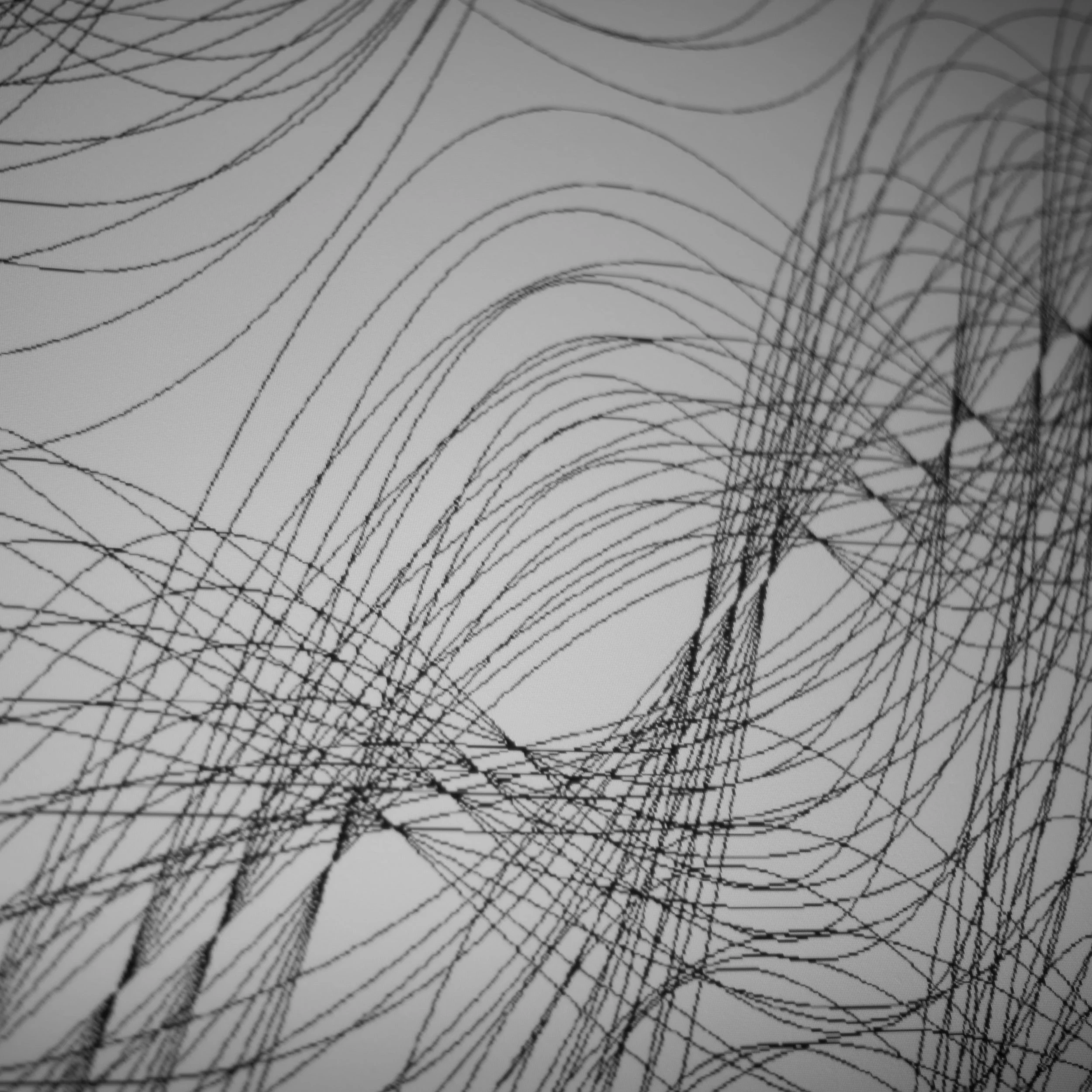 Black abstract lines and curves on a white background, forming a complex, tangled pattern.