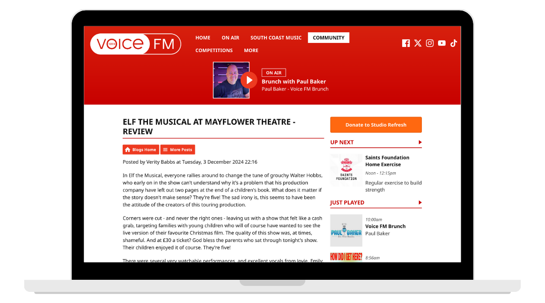 Screenshot of a laptop displaying a webpage for Voice FM radio station. The page features a review of the musical ELF at Mayflower Theatre and includes navigation links, a donation button, and recent broadcast information.
