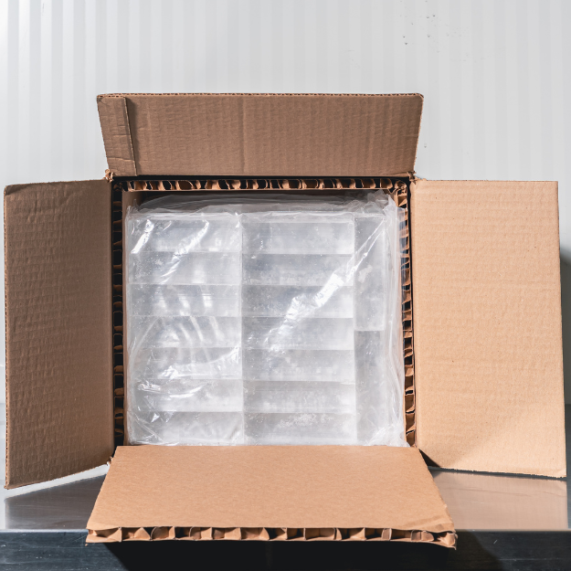 Open insulated cardboard box containing clear ice bags.