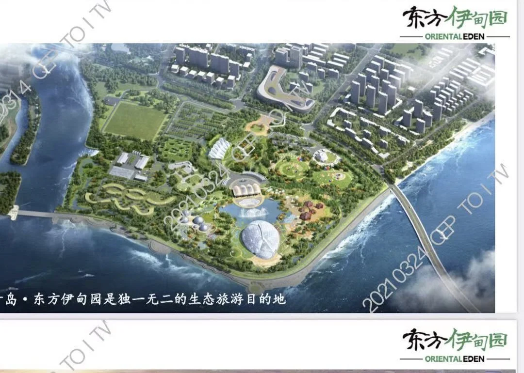 A detailed aerial view of Oriental Eden, a large eco-tourism park with lakes, forests, pathways, and various buildings, situated along a coastline with a bridge extending over the water.