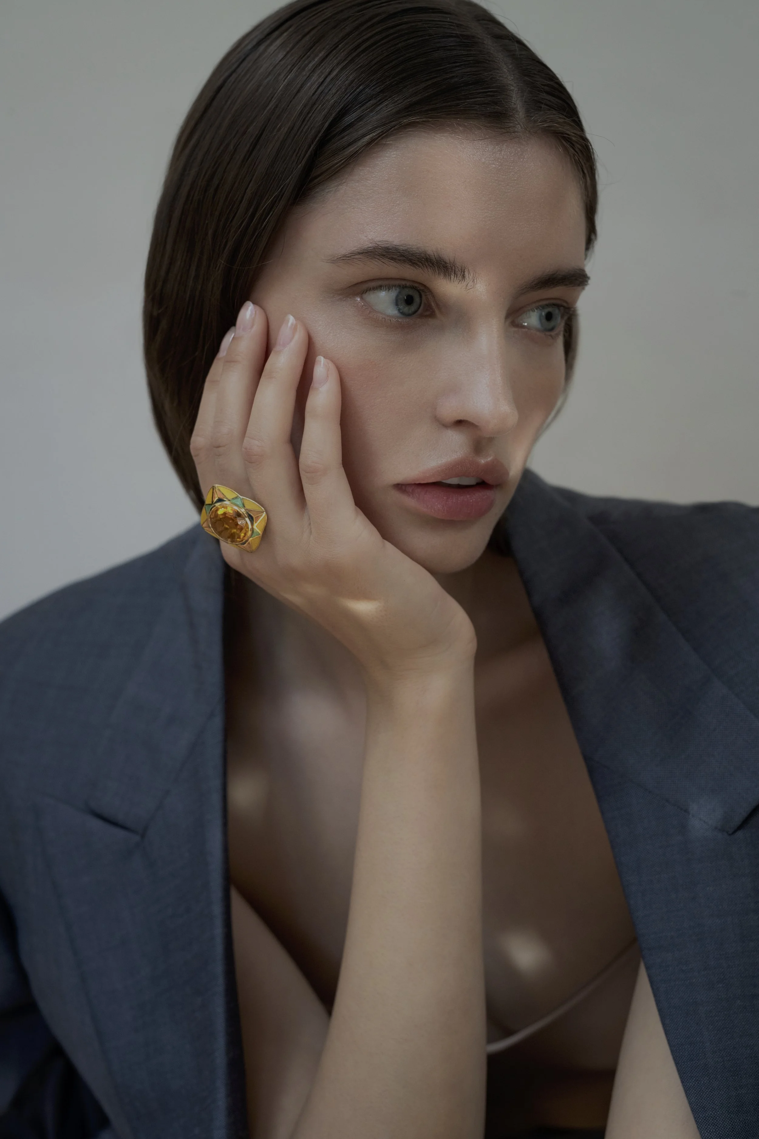 SUNRISE AURORA RING BY Tarra Rosenbaum. Gold ring with a large, faceted yellow citrine and vitreous enamel.