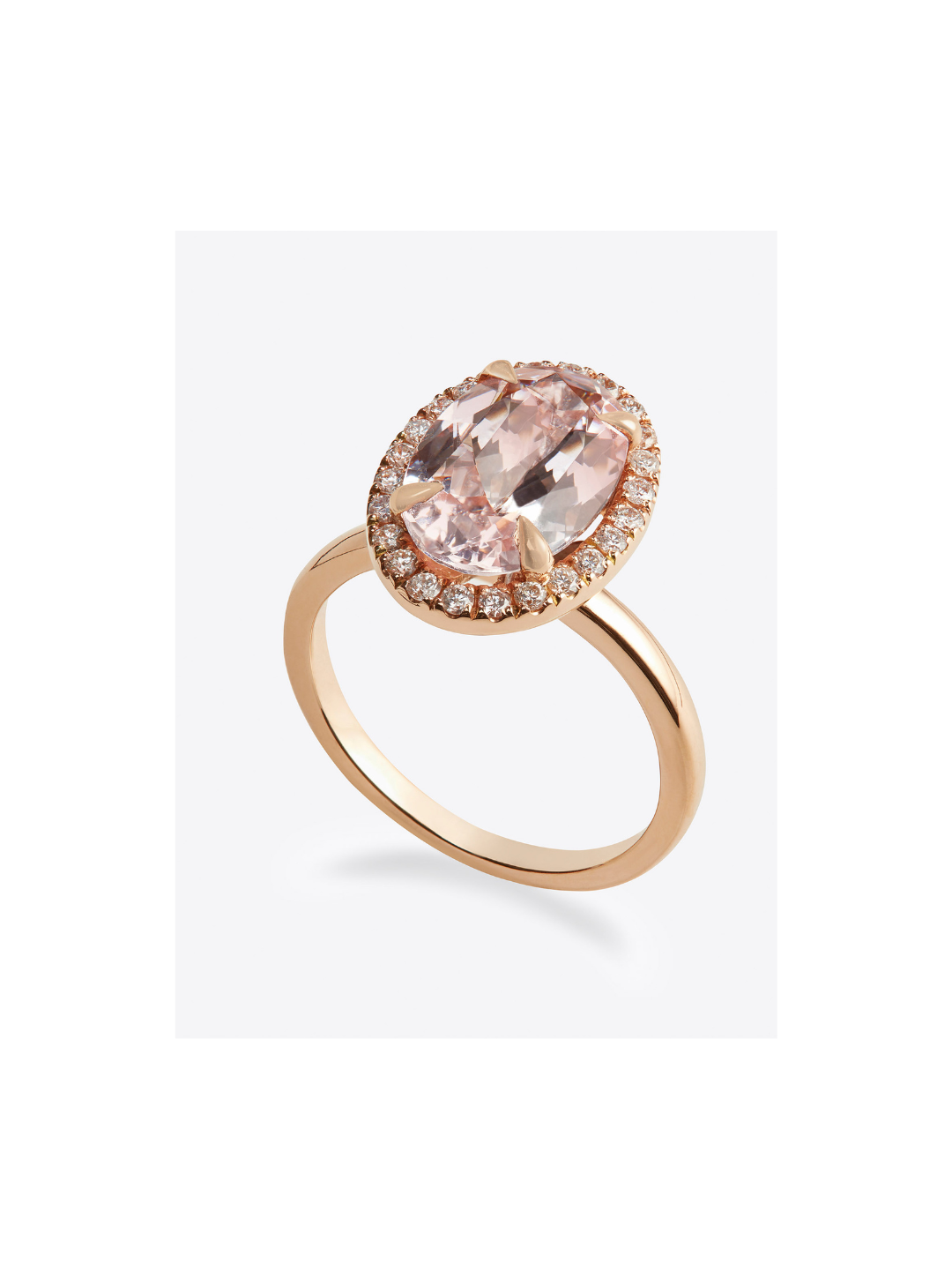 Gold ring with a large oval pink gemstone surrounded by small diamonds.