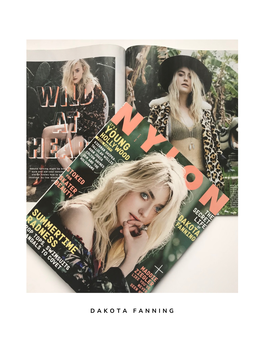 Close-up of a magazine cover featuring Dakota Fanning with blonde hair, wearing a colorful top, and striking a pose with her hand near her mouth.
