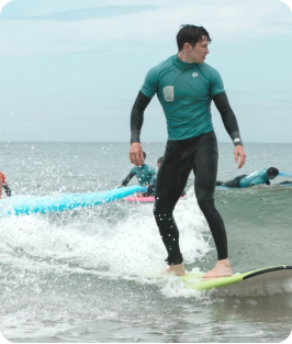A beginner surfer on a small wave