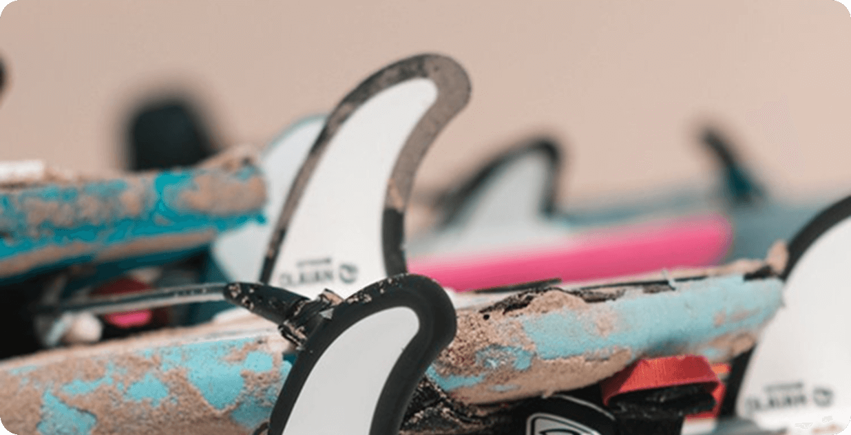 Close-up surfboards on the sand on a beach.