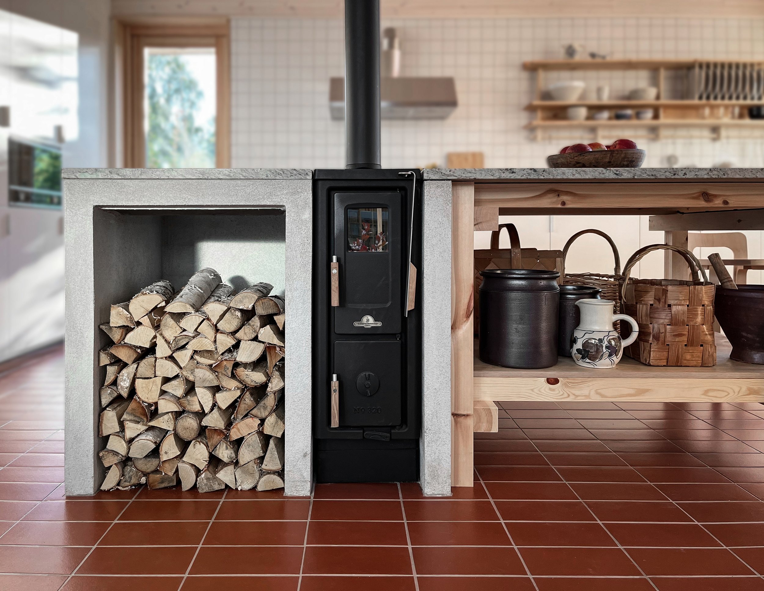 Wood-burning stove with stacked firewood on the left, and kitchen shelves with dishes and containers on the right, in a cozy kitchen with red tile floor.